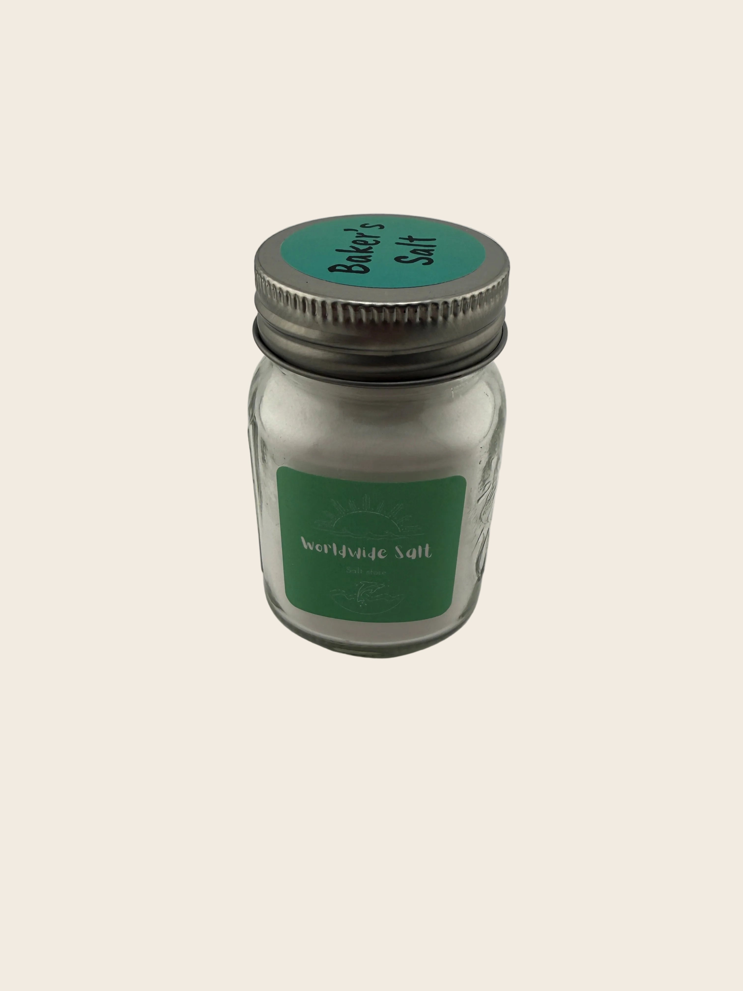 Small glass jar with a green label on a light gray background