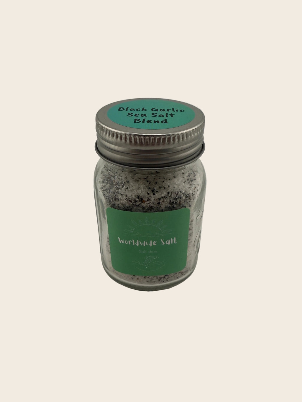 Jar of black garlic salt blend with a green label on a gray background