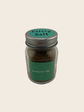 Jar of celery salt on a light gray background