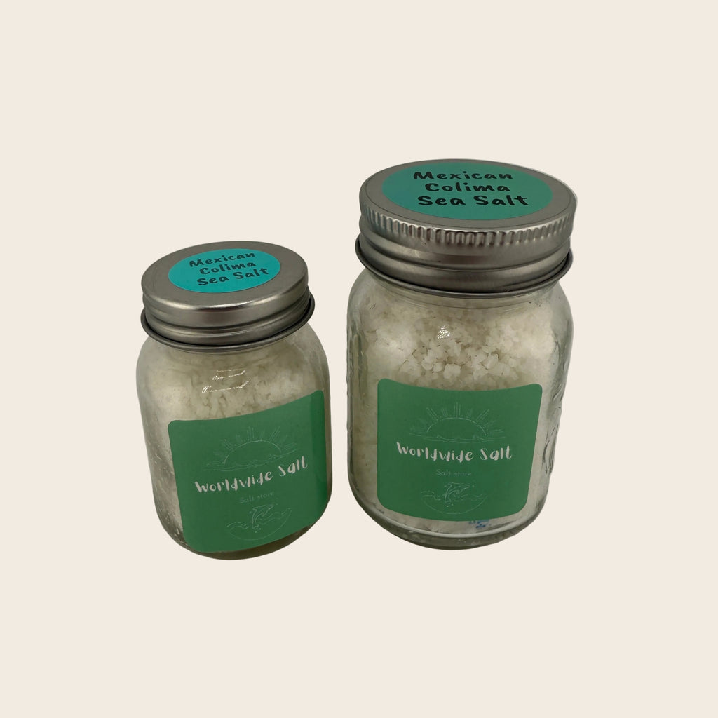 Two jars of Mexican Colima Sea Salt with green labels on a light gray background