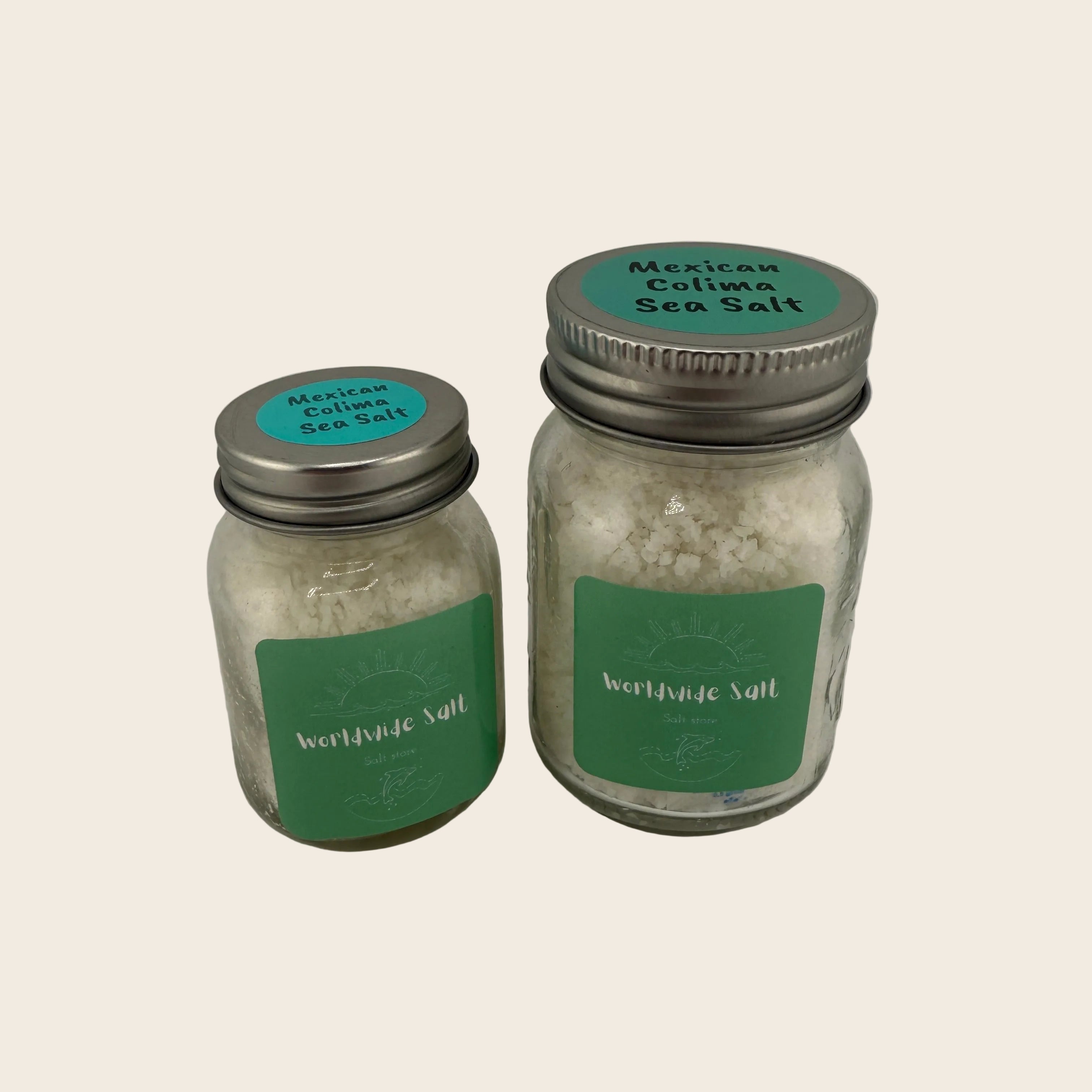 Two jars of Mexican Colima Sea Salt with green labels on a light gray background