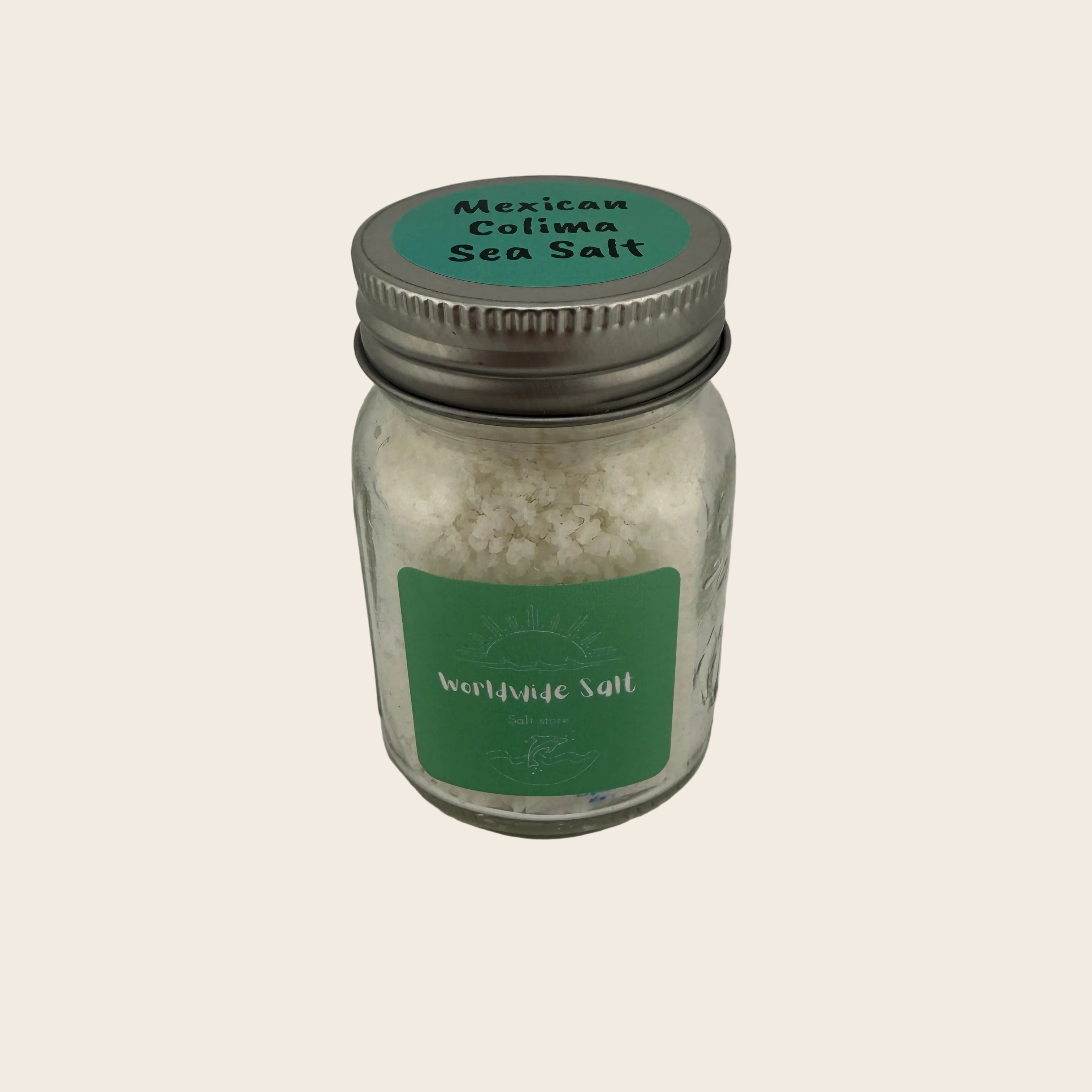 Jar of Mexican Colima Sea Salt with a green label on a light gray background
