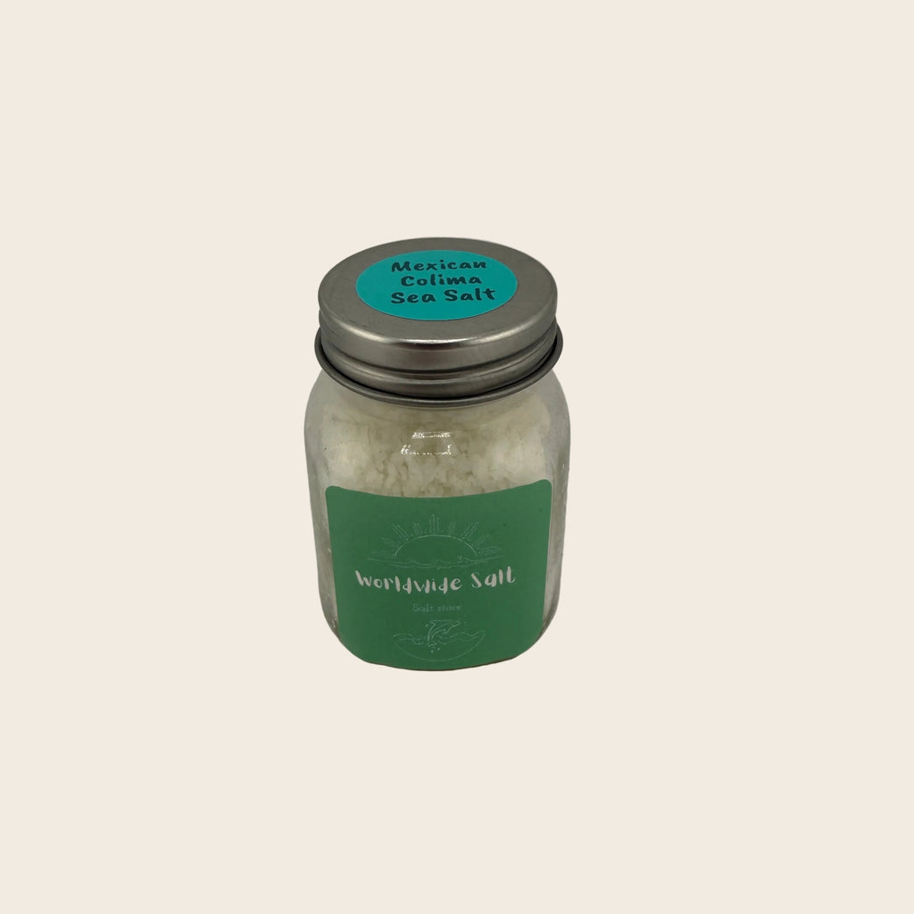 Jar of Mexican Colima Sea Salt with a green label on a gray background
