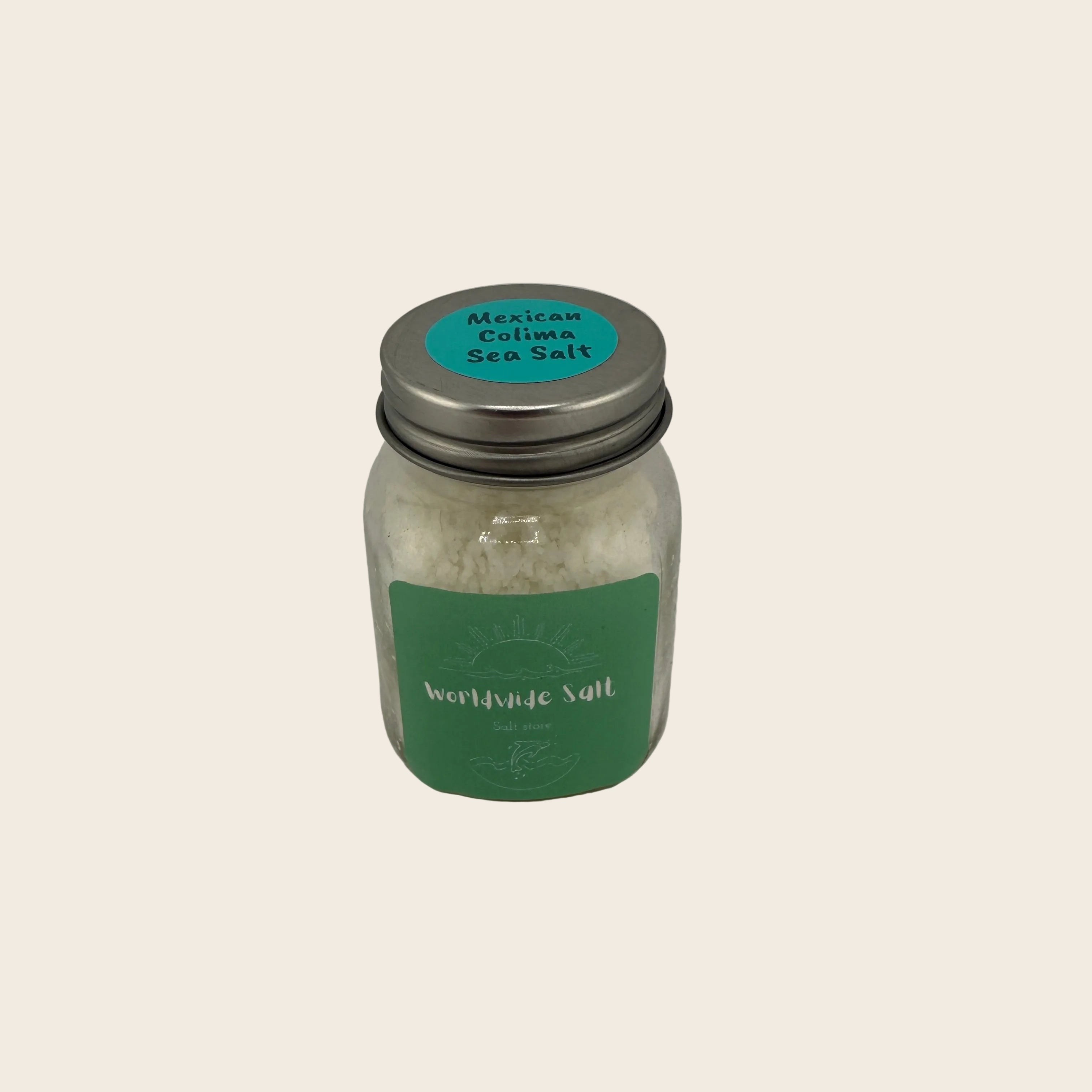 Jar of Mexican Colima Sea Salt with a green label on a gray background