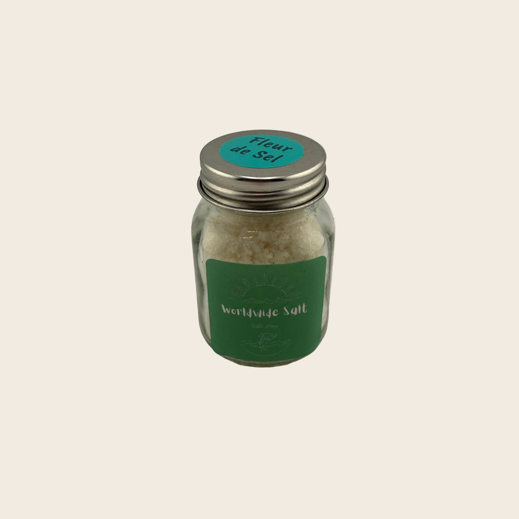 Jar of fleur de sel with a green label on a gray background