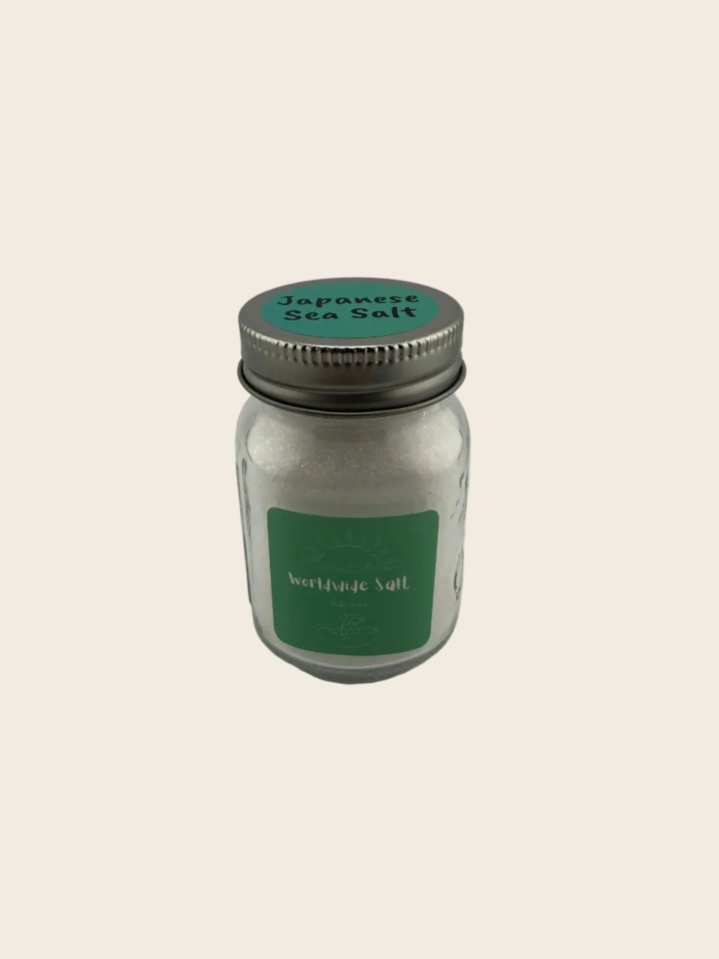 Small glass jar with a metal lid on a gray background