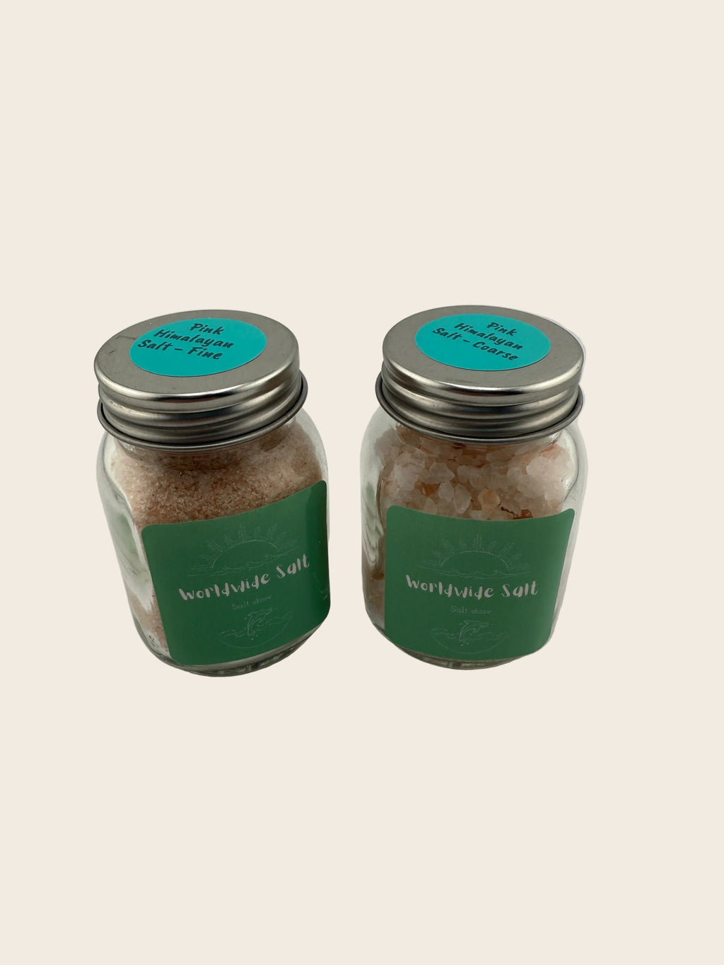 Two small jars with green labels on a light gray background