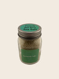 Jar of French Grey Sea Salt with a green label on a neutral background